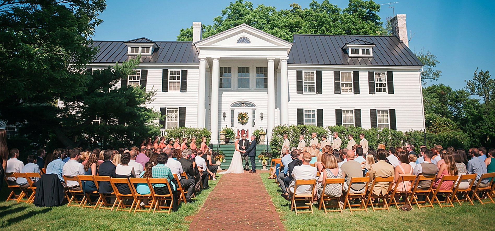 A wedding ceremony on the front lawn of the Midland Farm mansion